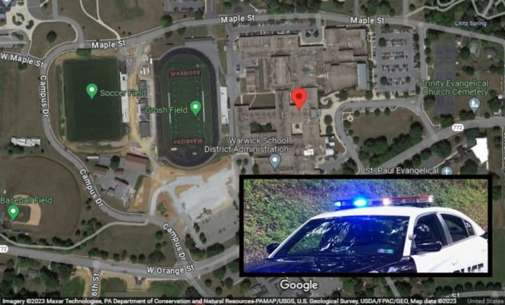 A map showing the Warwick School District where the boy was cited and a police vehicle with its lights on.&nbsp;
