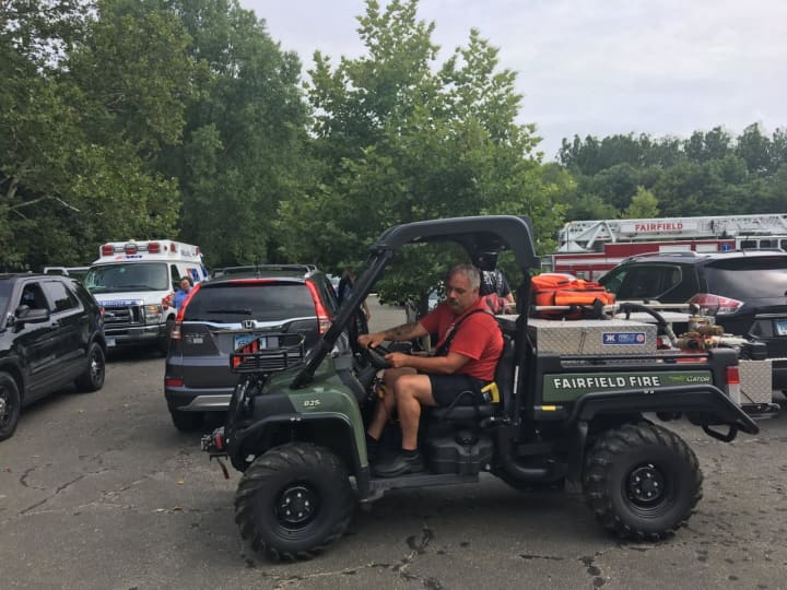 Fairfield firefighter Jeff DeNitto operates the Gator 1 off-road vehicle to help an injured hiker Friday at Lake Mohegan.