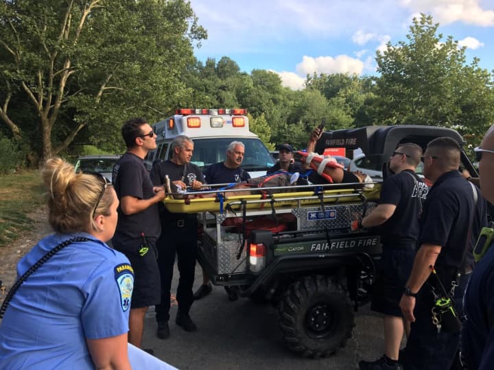Fairfield first responders assist a cyclist who took a bad spill while trail riding in the Lake Mohegan open space area Sunday.