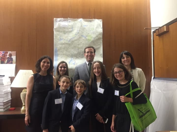 Moms and their kids meet with Assemblyman David Buchwald to dicuss legislation to allow bus drivers to administer epinephrine if a child is having an allergic reaction.