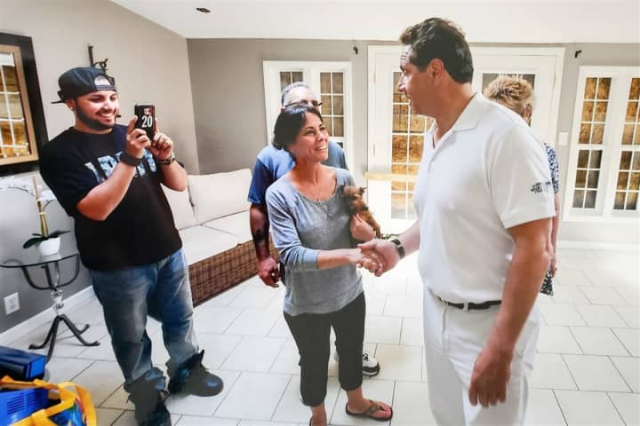 New York Gov. Andrew Cuomo meets Sherry Vill while touring flood damage in Greece.