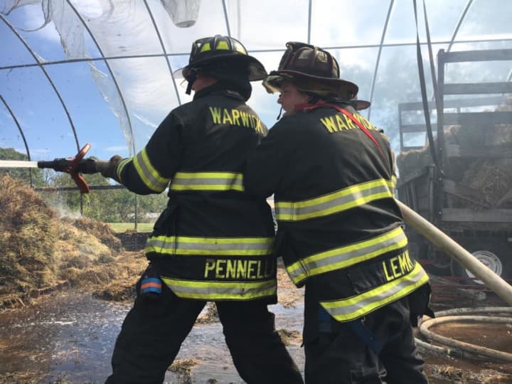 The Warwick Fire Department works to extinguish a greenhouse fire on Wednesday.
