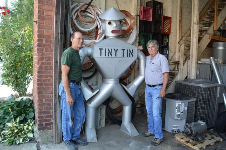 Glen Mills and Bill Gesner flank the tin man in their Hillsdale sheet metal shop.