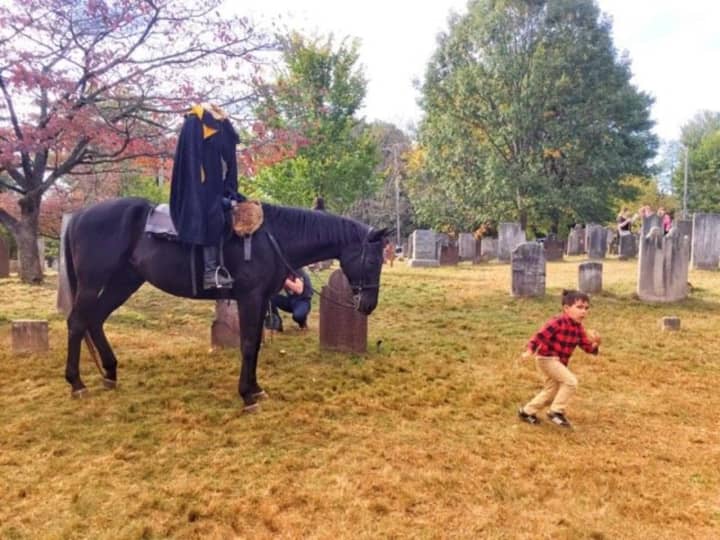 One youngster runs into The Headless Horseman at Sleepy Hollow Cemetery.