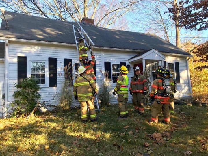 The Brookfield Volunteer Fire Dept. Candlewood Company works at a home with smoky conditions Thursday on Oak Grove Road.