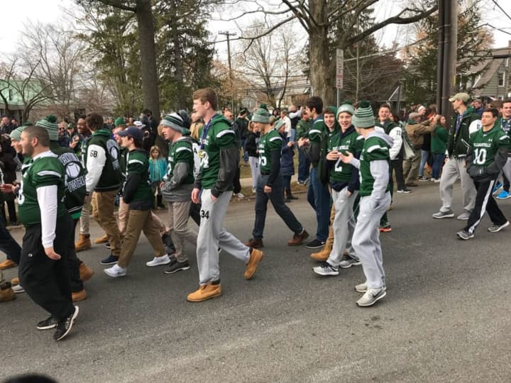 The Pleasantville Panthers football team parade through town