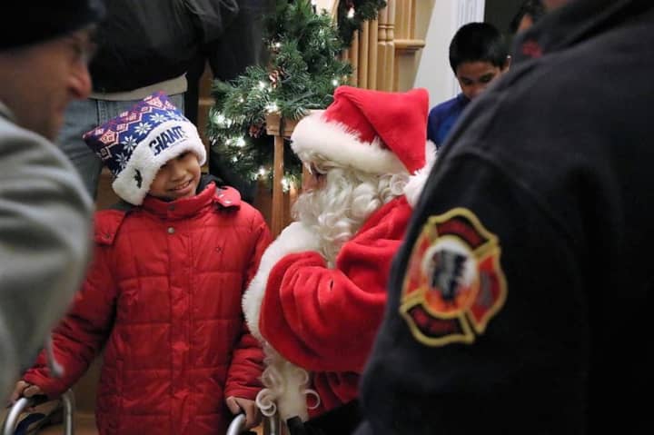 Austin, 8 of Moonachie, was surprised by firefighters and Santa Claus on Saturday.