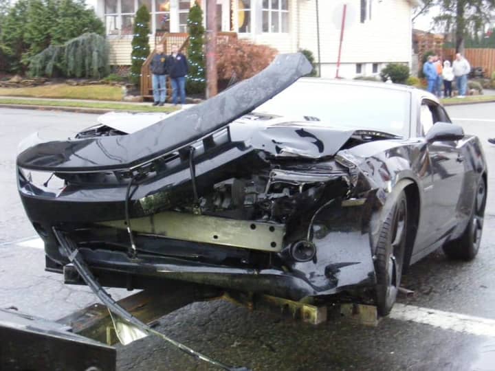 A Chevrolet Camaro was hit after a Nissan Altima ran a stop sign, hitting the sports car and then a house Saturday.