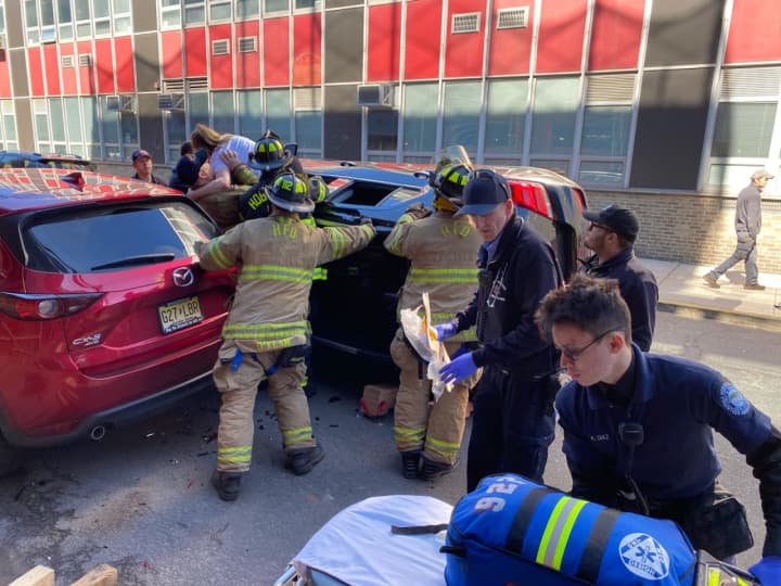 Hoboken firefighters stabilize the vehicle while extricating the mother and daughter.