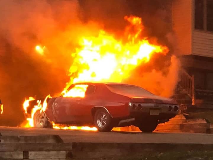 Fire crews in Sussex County were quick to douse a massive car fire that spread to a nearby home Sunday evening.