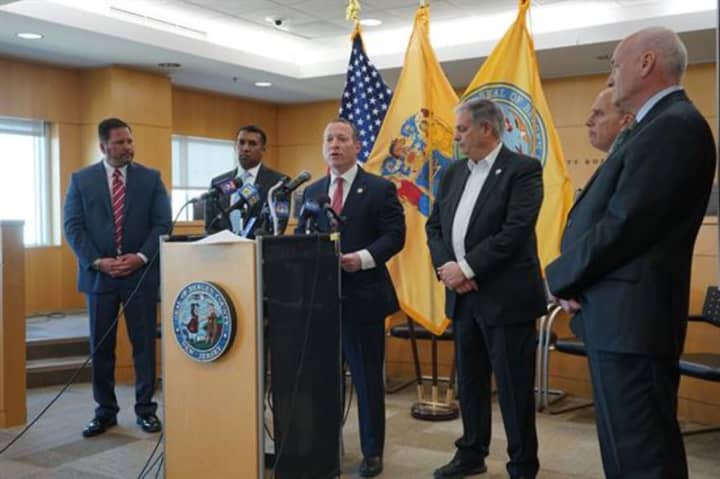 Tedesco at news conference in Teaneck immediately to the right of Congressman Josh Gottheimer (speaking at the podium). Maron is at right.