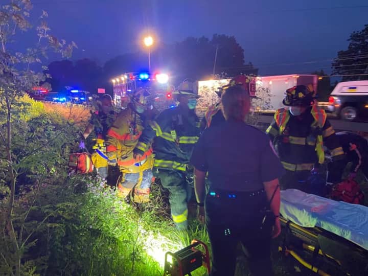 A driver was rescued and rushed to a nearby trauma center after a vehicle plunged down a steep embankment and landed in a pond in Hunterdon County, authorities said.