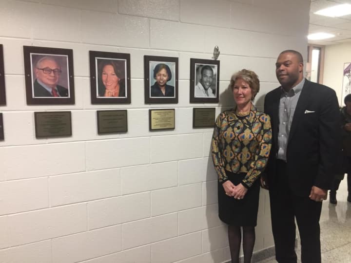 New Wall of Fame inductees Madeline de Vries Hooper and Rasaun Young with photos of themselves and the other two inductees, who could not attend.