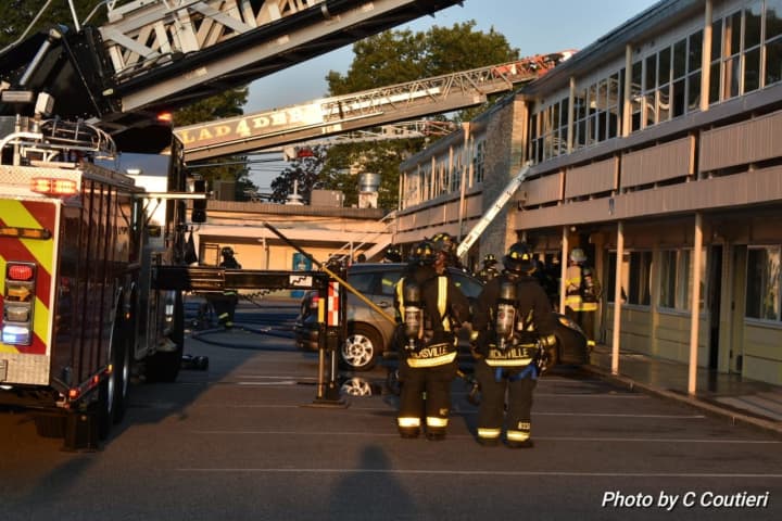 Hicksville firefighters battle a blaze at a Long Island hotel.