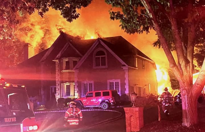 Flames spread through the rear first and second floors of the $1.1 million, 3,400-square-foot home on Urban Club Road in Wayne before dawn Friday, Sept. 30.