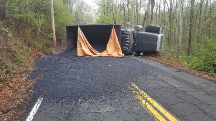 A dump truck turned over in New City, spilling asphalt and closing South Mountain Road.