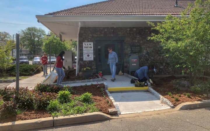 Volunteers spruce up the exterior of the building earlier this year.