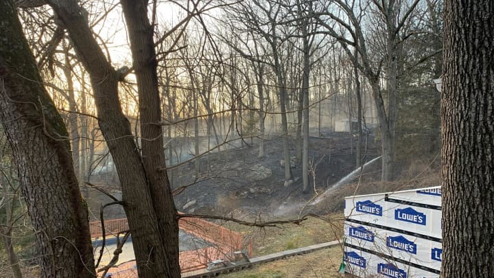 Firefighters battle a brush fire in Mahopac located in the area of Tulip Road.