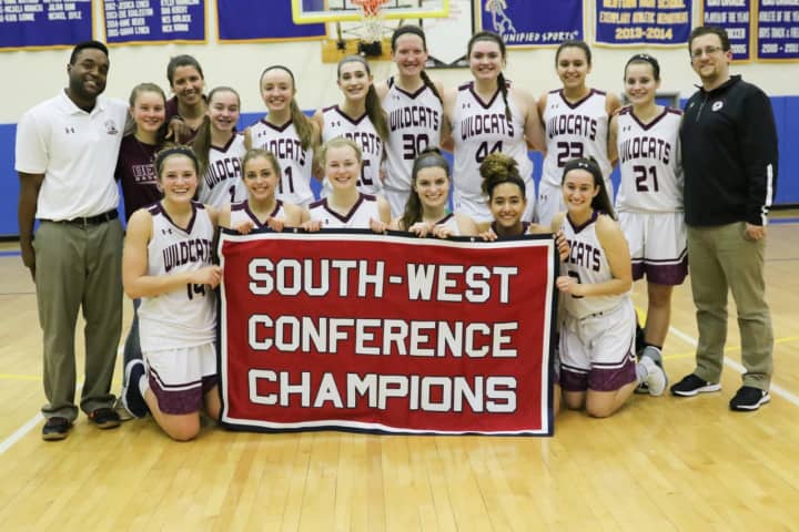 The Bethel High School girls basketball team celebrates its first South-West Conference championship Wednesday night.