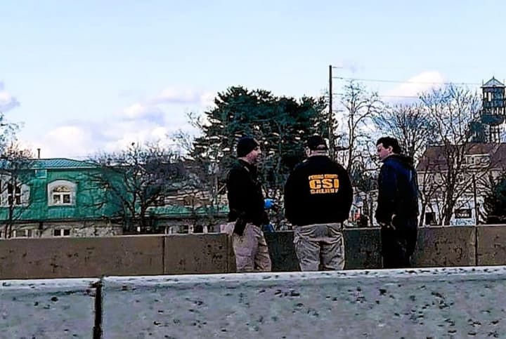 Passaic County Sheriff Richard Berdnik&#x27;s forensic detectives with Clifton police on a bridge overlooking the riverbank.