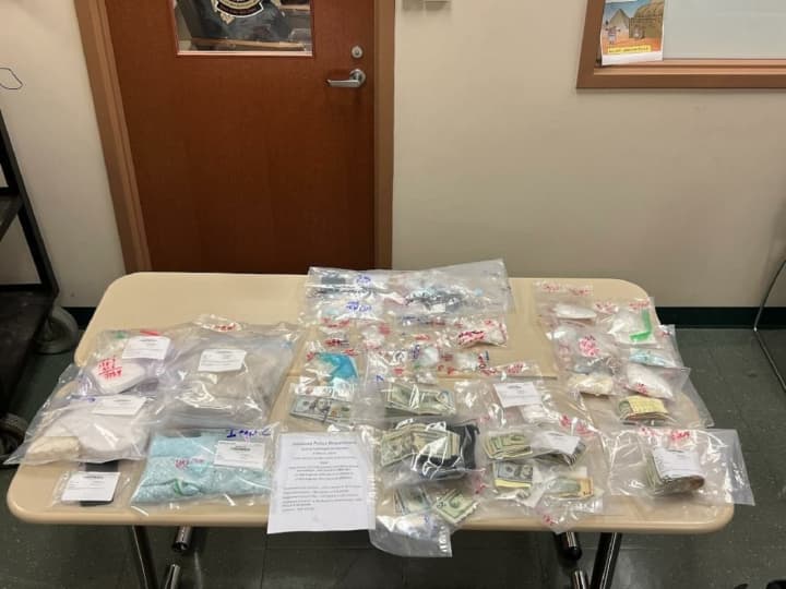 Police released an image of some of the cash and narcotics that were seized from homes in Danbury and New Milford.