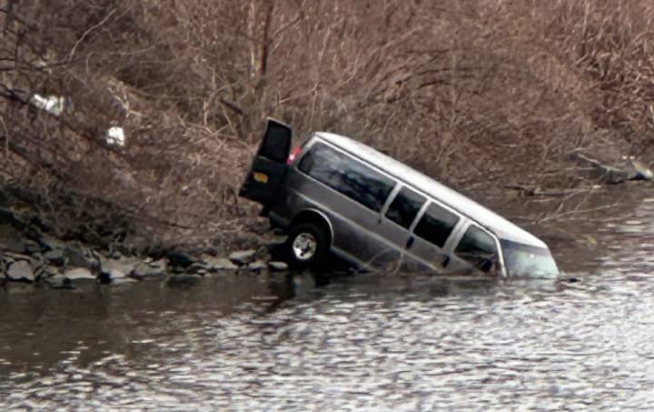 The driver refused medical aid after his van ended up in the drink.
