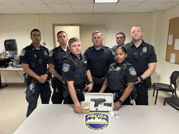 White Plains Public Safety officers are pictured with the illegal narcotics and loaded firearm seized in the arrests.