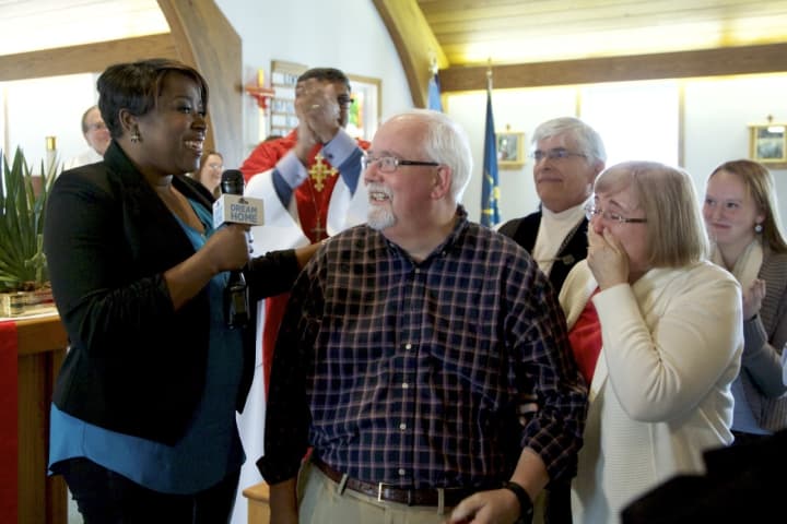 David Rennie of Shelton is surprised at his church by HGTV host and interior designer Tiffany Brooks with the news that he is the winner of the HGTV Dream Home 2016 on Merritt Island, Fla.