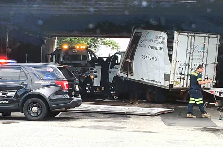 The truck tipped beneath the Route 80 overpass at River Road and Market Street in Elmwood Park shortly after 1 p.m. Friday, July 14.