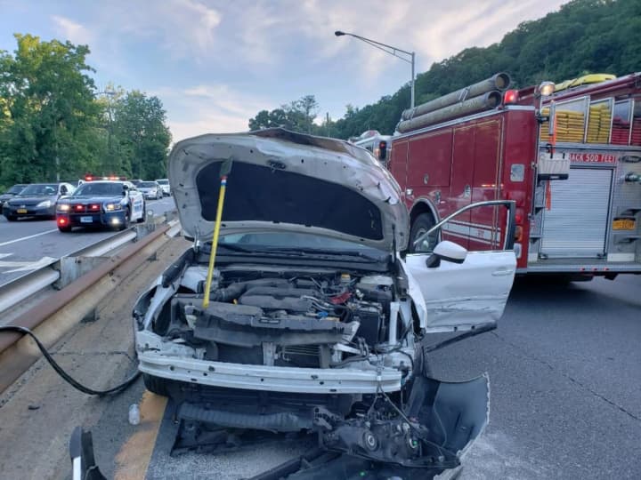 A car went airborne after striking a guardrail on the Saw Mill River Parkway in Dobbs Ferry, landing on two other vehicles.