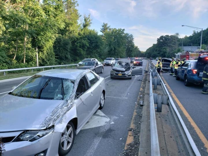 A car went airborne after striking a guardrail on the Saw Mill River Parkway in Dobbs Ferry, landing on two other vehicles.