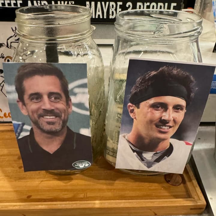 Aaron Rogers and Tommy DeVito tip jars.