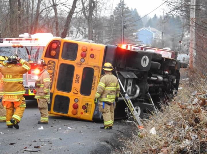 The driver of a school bus was injured when the vehicle rolled on its side.