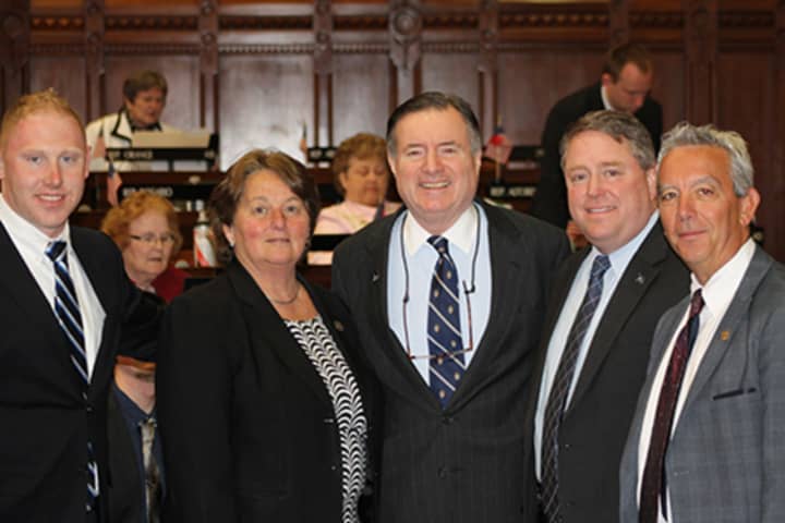 State Reps. Stephen Harding and Jan Giegler welcome Western Connecticut State University President John Clark to the state Capitol.