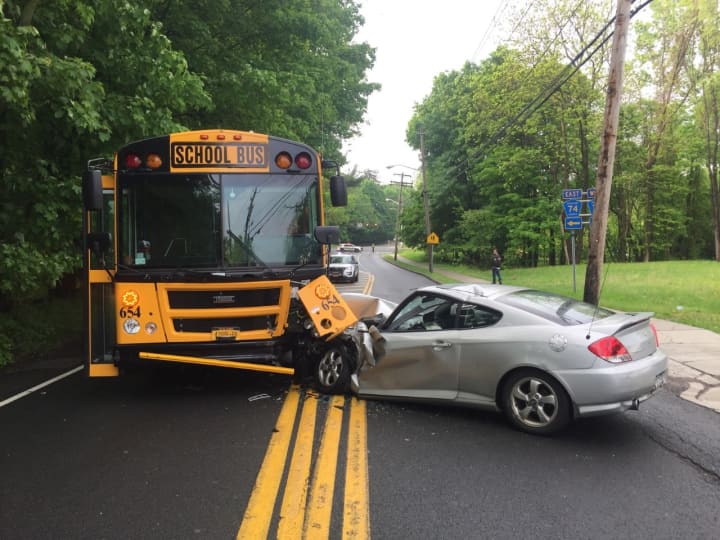 One person was injured when a car crashed into an unoccupied school bus.