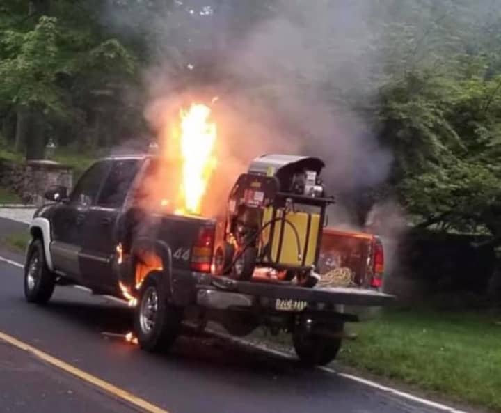 A fire in the back of a pickup truck closed a busy roadway for more than an hour.