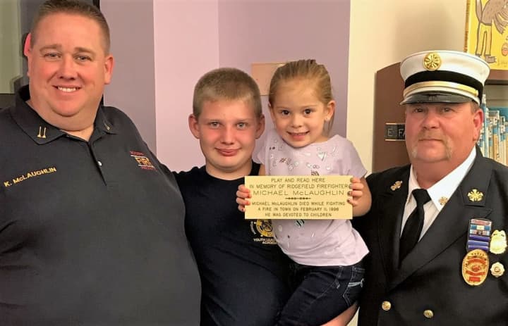 Left to right: Michael McLaughlin&#x27;s son, Kevin, who is now a Norwood fire chief, grandson Kevin, granddaughter Lucy, Ridgefield Fire Chief Michael Kees.