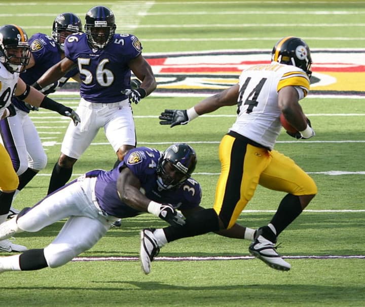 Baltimore Ravens pursuing Pittsburgh&#x27;s Najeh Davenport of the Pittsburgh Steelers in a 2006 NFL game.