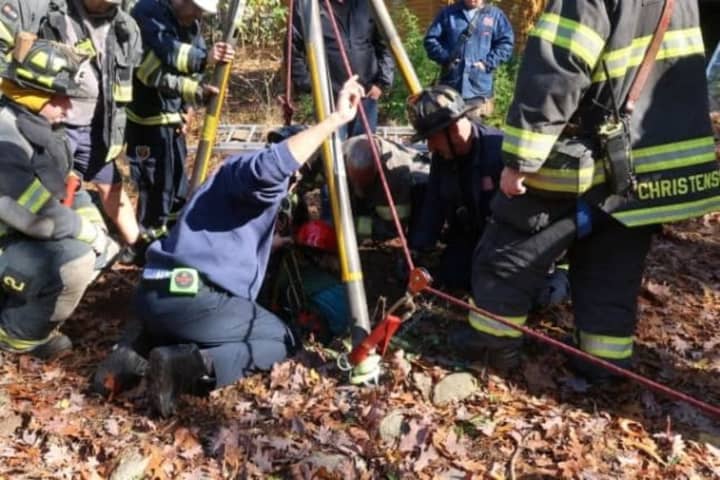 Rescuers get to the 68-year-old resident who fell into a dry well in Hillsdale.