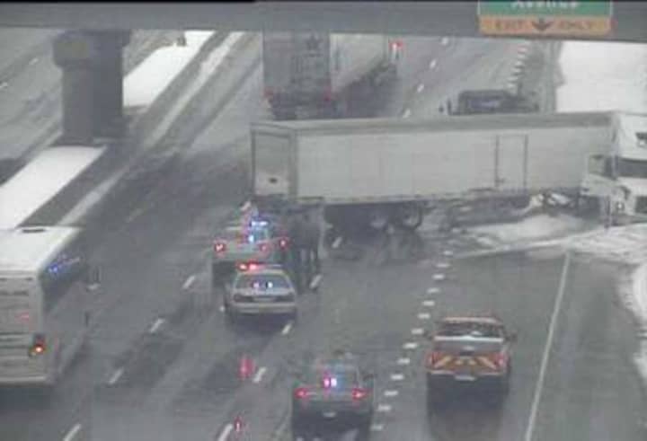 A jackknifed tractor-trailer blocks two lanes of I-95 southbound near Exit 15 for Stuart Avenue in Norwalk on Tuesday afternoon. The highway appears wet but not snowy as a storm rocks the area.