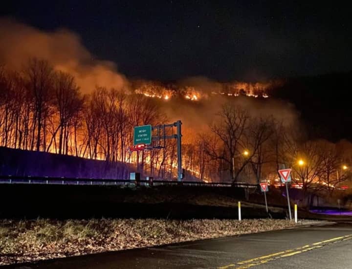The Mount Tammany wildfire burns Sunday night over Route 80.