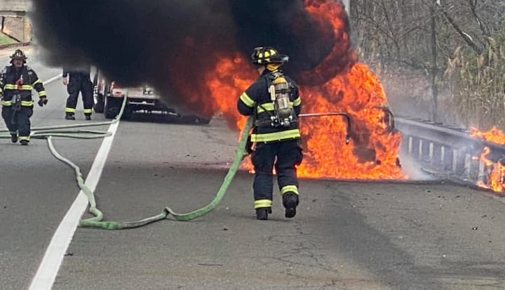 Washington Township firefighters douse the car fire on the Garden State Parkway.