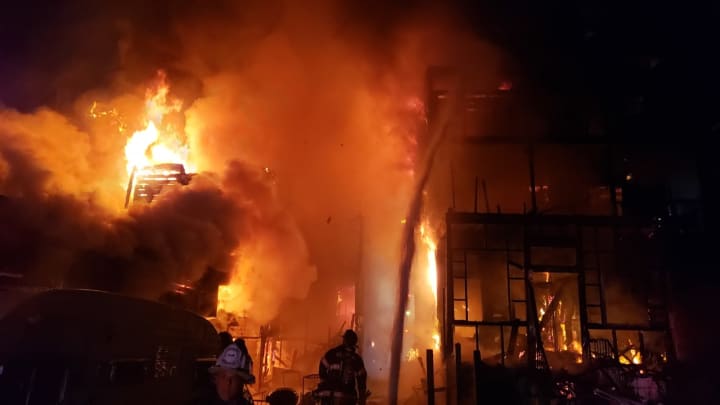 Four buildings were destroyed during a fast-moving three-alarm fire.