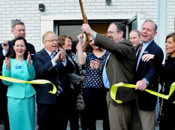 AFC Urgent Care Danbury co-owners Tom Kelly, holding the scissors, and Ron Krippner, second from right, cut the ribbon at the grand opening of their Main Street clinic in Danbury in 2013. AFC plans to open its third location in the city in February.