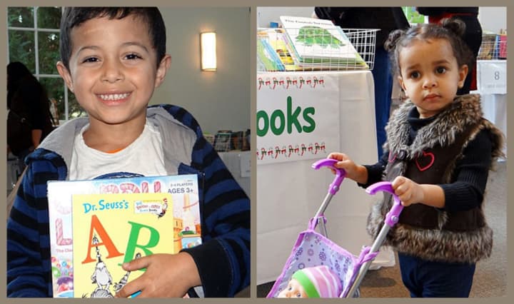 A youngster happily displays his Dr. Seuss and Candy Land, and even little ones came to browse, at last year&#x27;s Holiday Toy Drive.