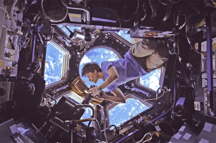 European Space Agency astronaut Samantha Cristoforetti takes pictures of Earth from the cupola of the International Space Station in a scene from “A Beautiful Planet,” a new IMAX movie opening Friday at The Maritime Aquarium at Norwalk.