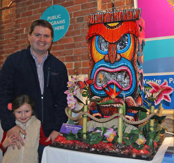 Brett Almstead, of Ridgefield, with daughter, Marin, with his second-place winner, “Tiki Island Lighthouse,” in The Maritime Aquarium at Norwalk’s 14th annual “Festival of Lighthouses Contest.”