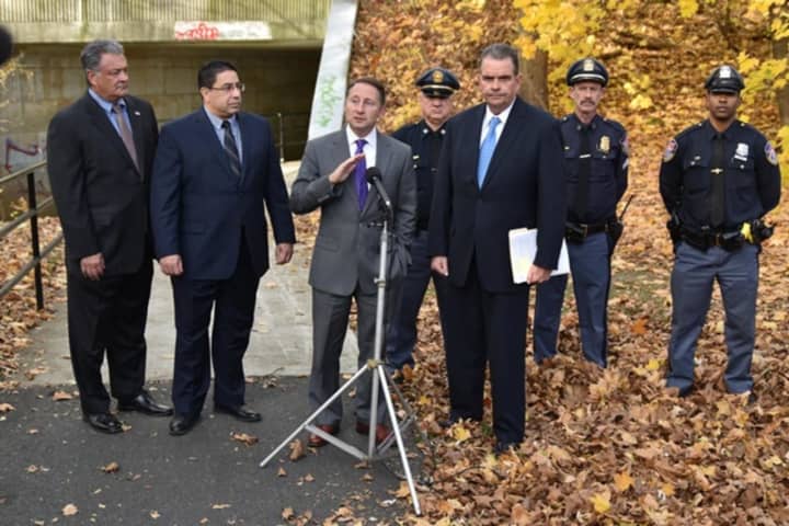 Rob Astorino, at microphone, reacts Monday to racist slurs and symbols that were found scrawled on a bike path in White Plains. Saying hate crimes will not be tolerated, the county executive vowed that the perpetrators will be found and punished.