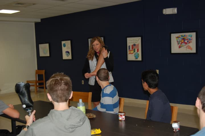 Retired U.S. Army Lt. Col. Patty Solimene Collins shows Byram Hills students an artificial leg.