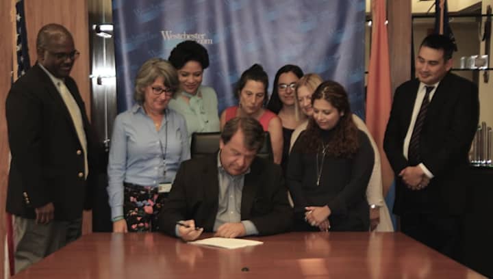Westchester County Executive George Latimer signing the bill.